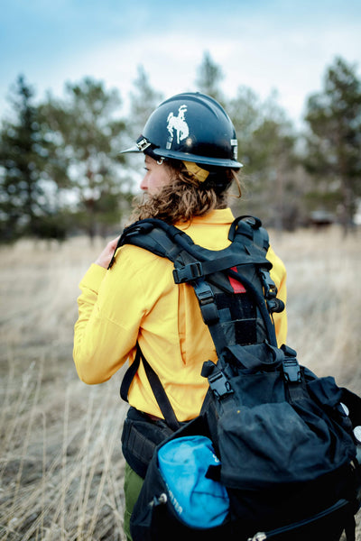 Wildland fire gear and pack on woman ready to work