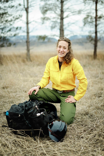 woman firefighter crouching packing her pack for work