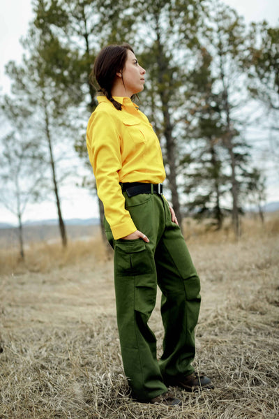 Woman firefighter looking across field towards work